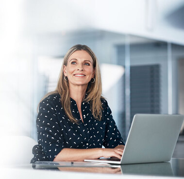 a woman typing on a laptop